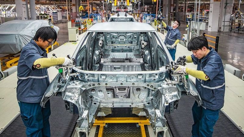 Advanced electric vehicle production line at a Chinese automobile manufacturing facility.