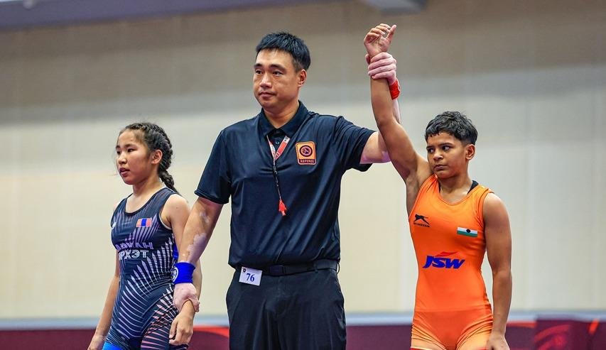 Indian women wrestlers celebrating gold medals in Hyderabad.