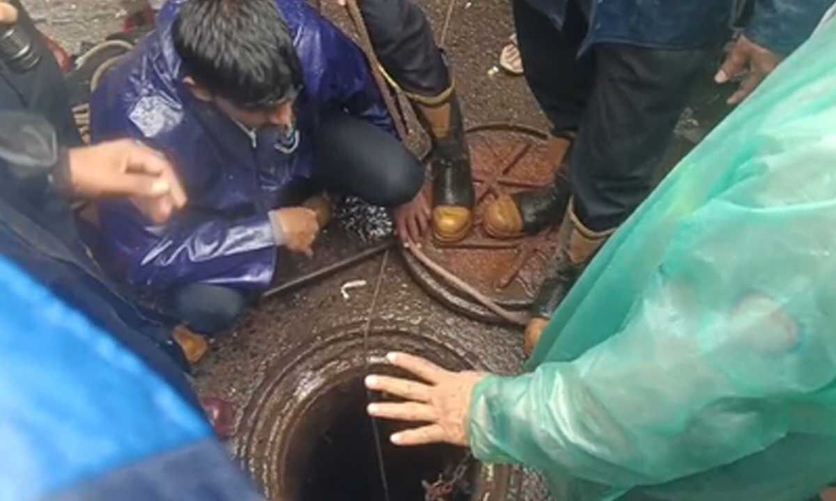 Rescue teams searching open drain near Miyapur underpass.