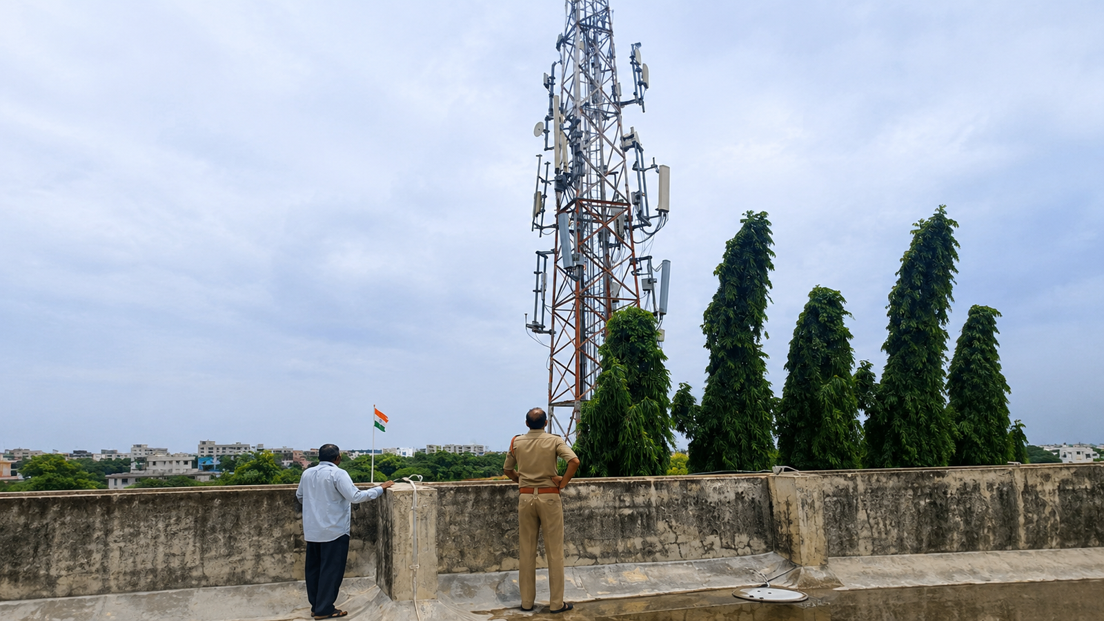 Man standing on BSNL tower during protest in Miryalaguda.