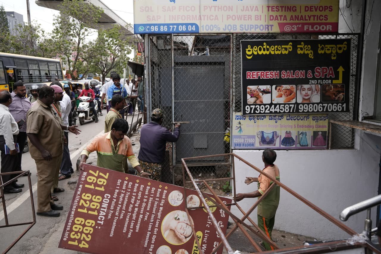 GBA officials removing footpath encroachments in Bengaluru.