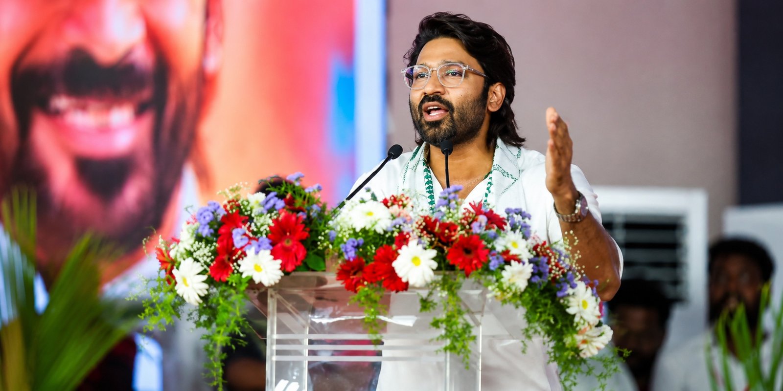 Dhanush addressing fans at a public event.