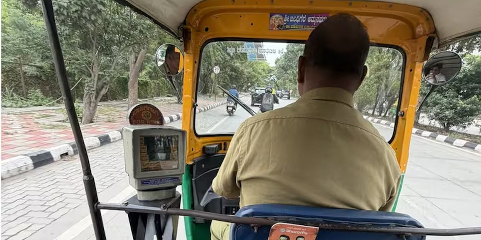 Auto driver comforting a woman during her journey to work