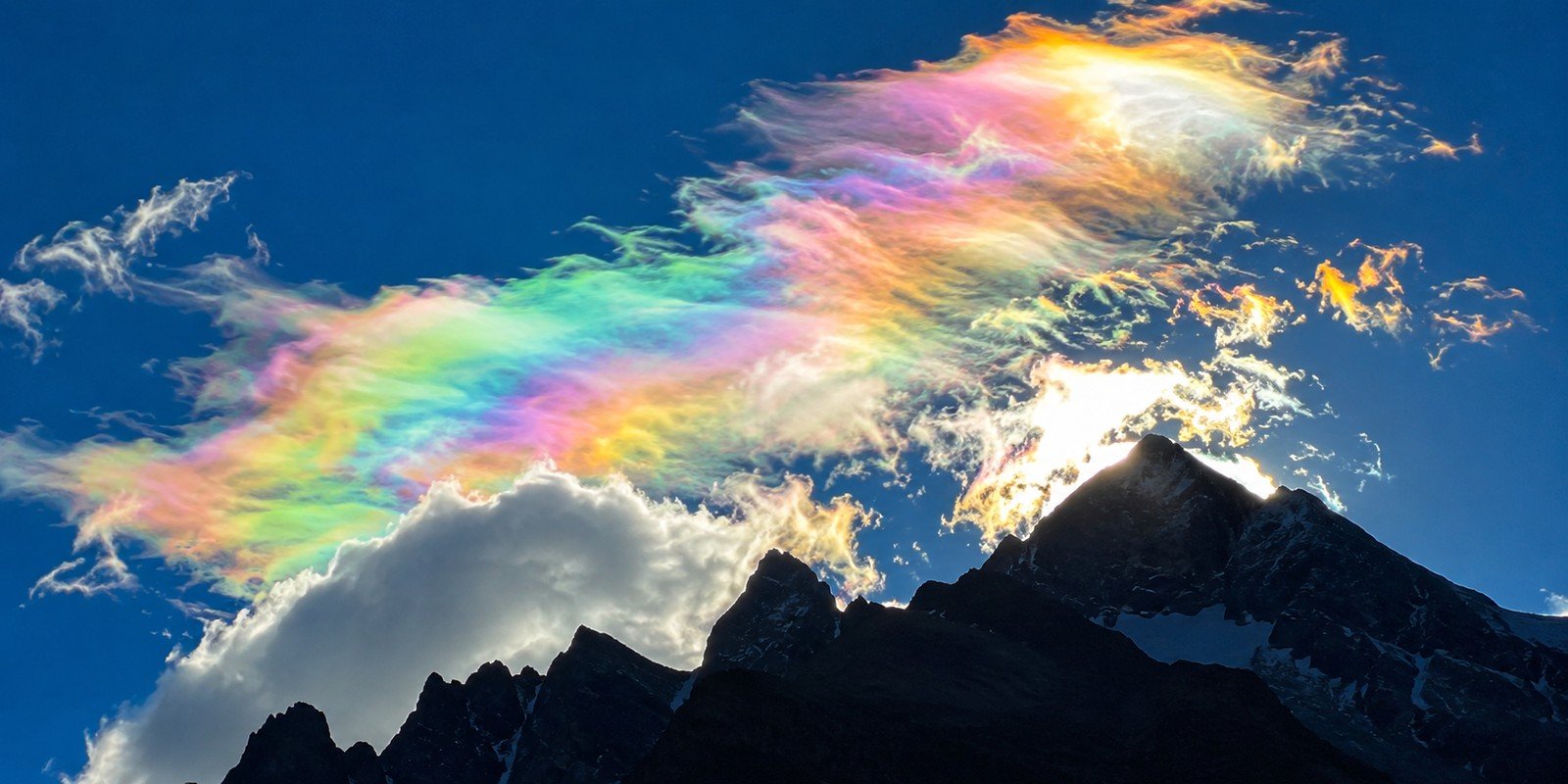 Rainbow-like iridescent clouds over Ladakh mountains