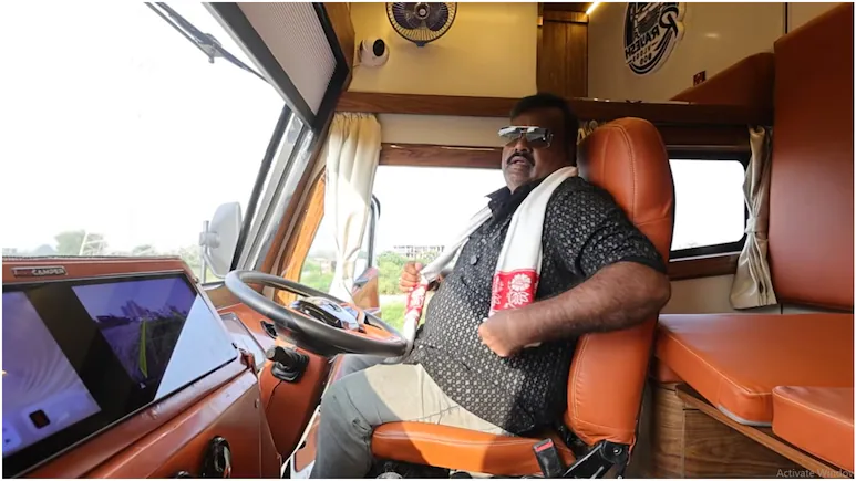 Rajesh Rawani standing beside his customised luxury truck