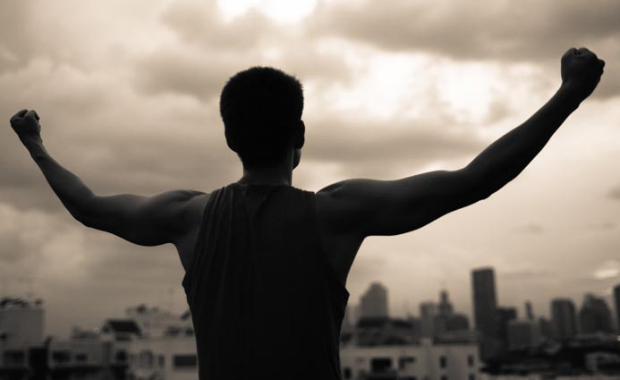 Man standing before mirror after overcoming failure