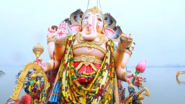 Devotees immersing a Lord Ganesha idol in water