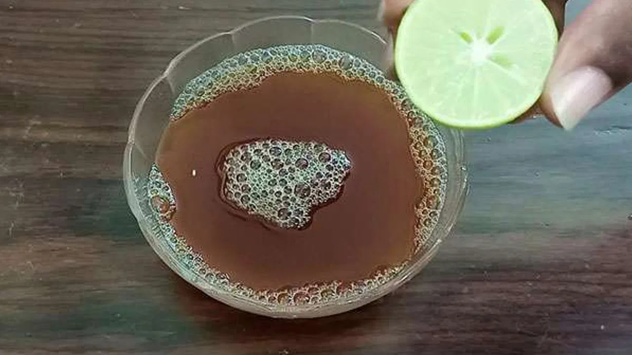 Woman applying natural hair care remedy to reduce hair fall.