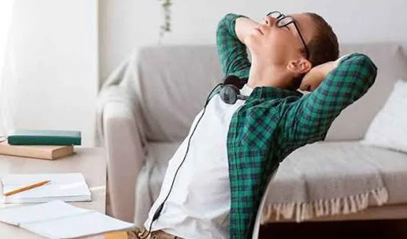 Young adult experiencing lower back pain after prolonged sitting.