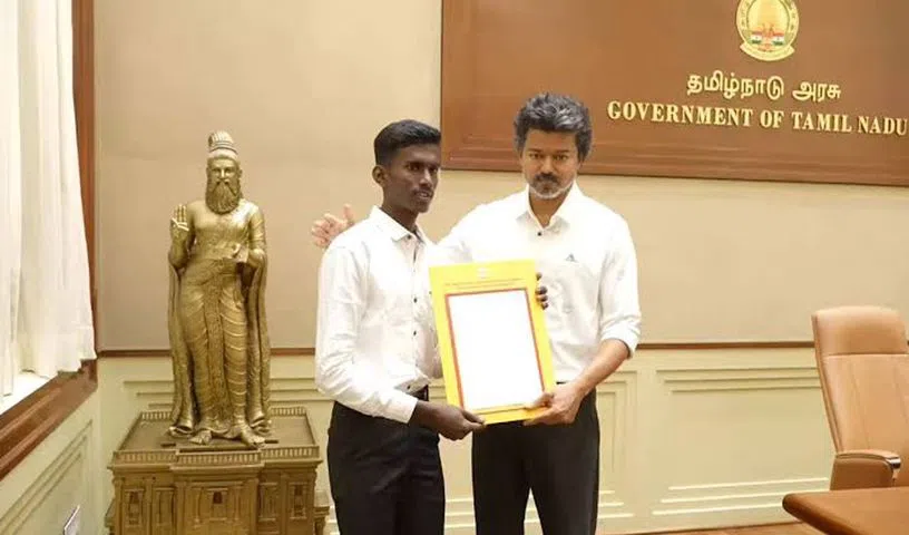 CM Vijay hands a government job appointment letter to Dinesh.